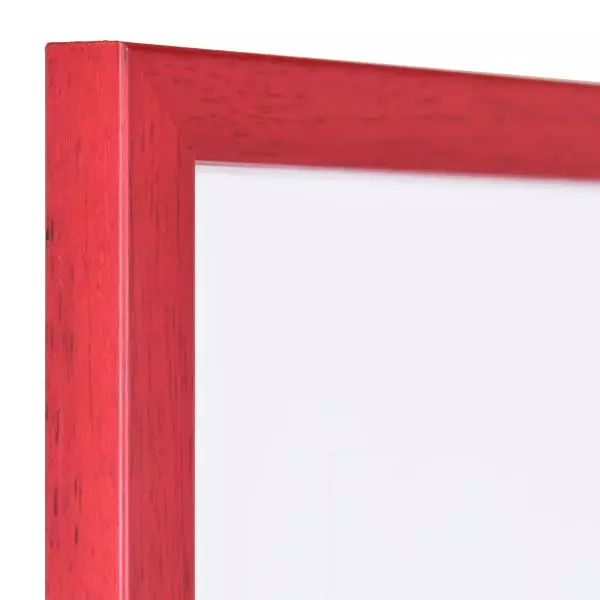 Ansicht der Ecke eines schmalen, rot lackierten Bilderrahmens mit sichtbarer Holzstruktur und glatter Oberfläche